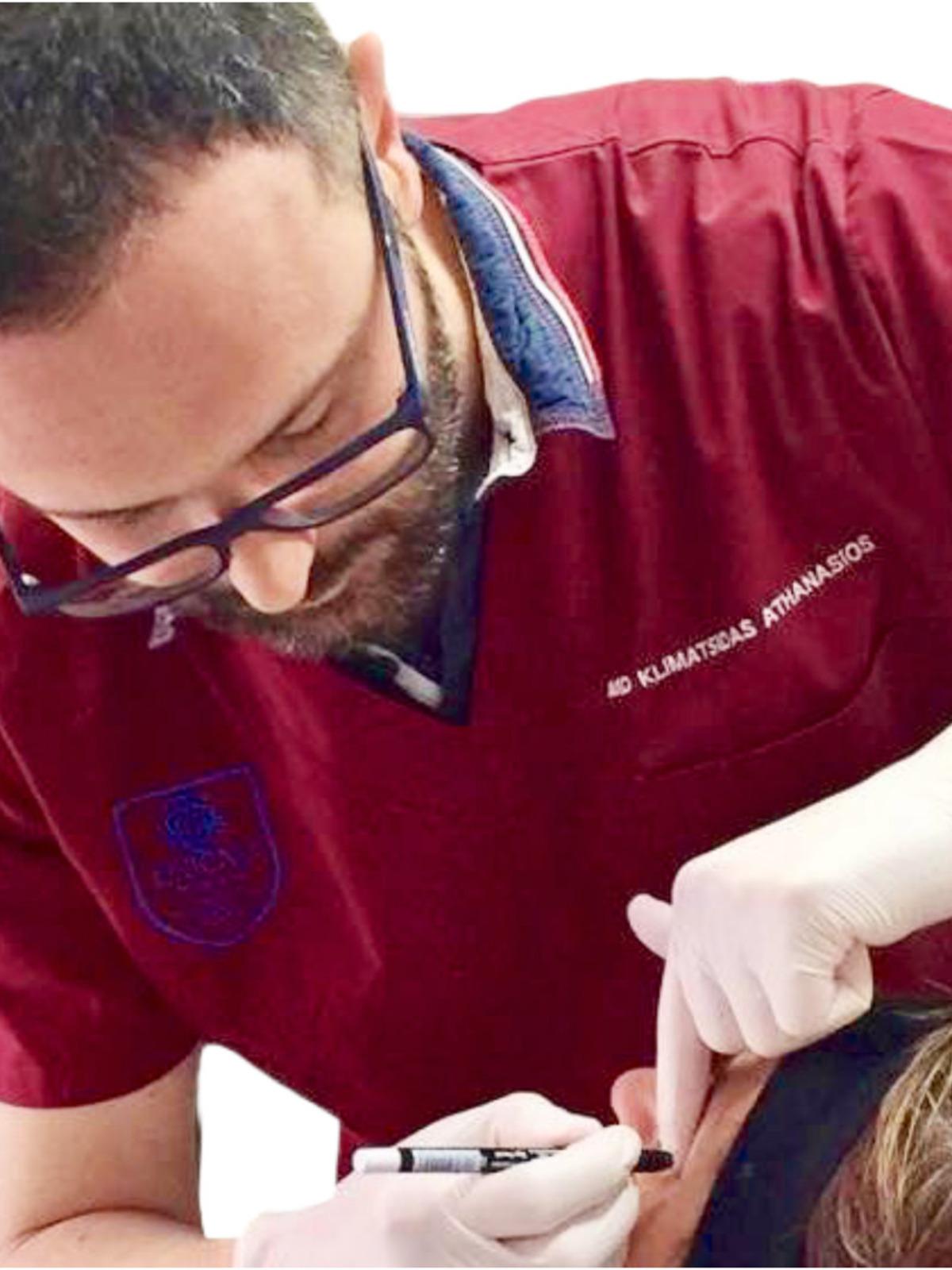 Dr. Athanasios Klimatsidas, MD Professional Background Image