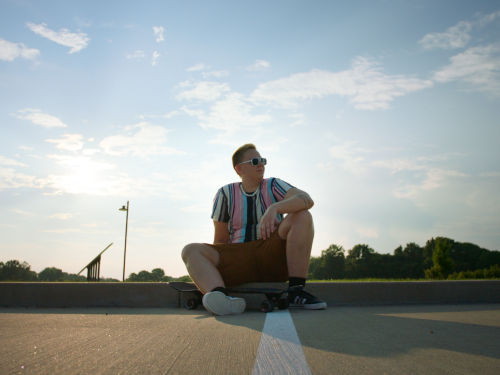 Kase outdoors sitting on a street curb